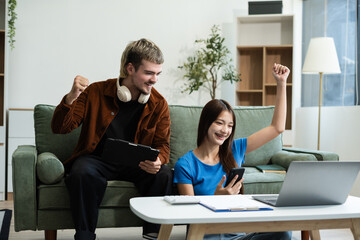 Lifestyle people, Happy young relaxed couple working on laptop computer at modern home.