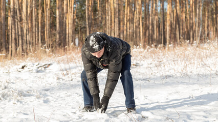 Man enjoying snowball fight in snowy winter park