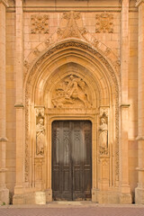 Gate with sculpture of Saint Georges on a horse, slaying a dragon. Detail of Saint Georges church...