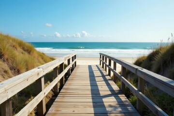 Obraz premium Scenic view of rustic wooden boardwalk on coastal dune beach with waves crashing, ocean, landscape