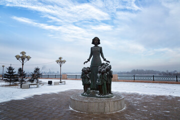  The monument to the teacher surrounded by children on the Lower embankment in Irkutsk, Russia