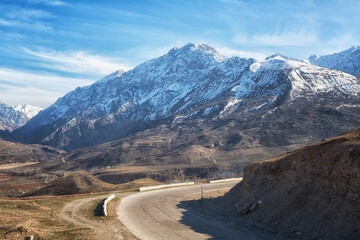 Chimgan Mountains and highway in Uzbekistan on a spring day