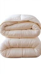 Fototapeta premium Folded ivory down comforter on white background studio shot for bedding or linen product catalog or website