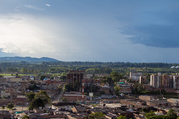 Urban view of Popayán, Popayan, with a mix of traditional and modern buildings surrounded by...