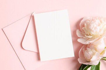 White wedding invitation or save the date card mockup with pink peony flowers and envelope, blank...
