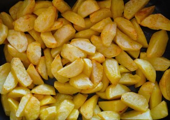Baked potatoes in the oven.
Close-up of sliced and browned potatoes baked in the oven. Golden...
