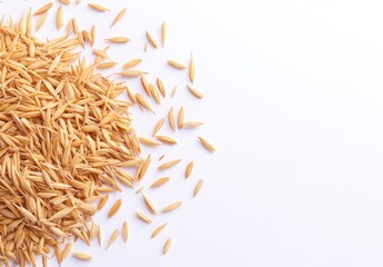 Light tan oat seeds scattered on white background.  Close-up view of  small, oblong-shaped seeds.  Healthy, whole grains
