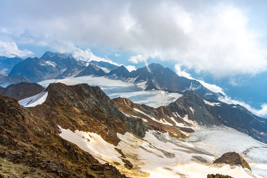Fototapeta Breathtaking panorama of the Otztal Alps showcases rugged peaks and expansive glaciers from the summit of Wildspitze in Austria, capturing nature's majestic beauty in clear daylight.