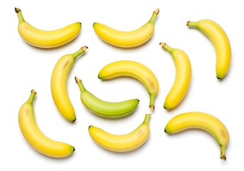 A top down view of several yellow bananas and one green banana on a plain white background surface top