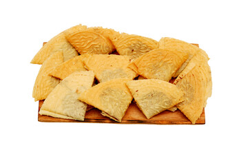 Kue Semprong or Asian egg roll. Indonesian traditional wafer snack made by clasping egg batter using an iron mold. Inside chocolate sauce, served on wooden plate and isolated on white background  