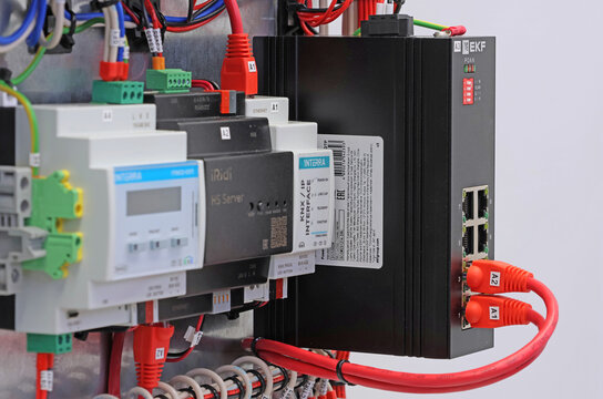 Ethernet data switch with connected cables with Rj45 connector from EKF. Installed on the metal circuit board of the DKC panel. 
