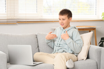 Mute boy using sign language during video call at home