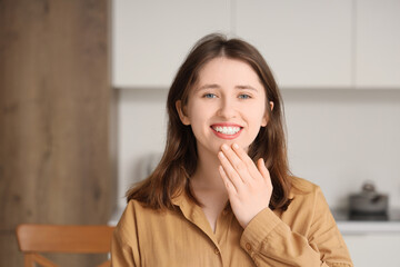 Young mute woman using sign language at home