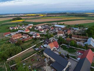 Aerial drone view of beautiful yellow fields rapeseed.Village country farming shapes in fields. Spring fields of yellow blooming rapeseed, growing plants. Fields in the Opole village from a drone.