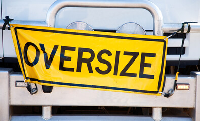 Yellow oversize sign attached to the front on a truck