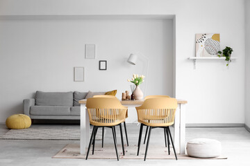 Interior of dining room with table, sofa and lamp