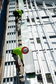 Construction workers with metal framework on an industrial building site