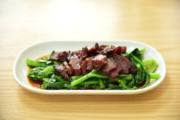 Honey Roasted Char Siu and Chinese flowering cabbage. Traditional Cantonese cuisine. Chinese delicacies.

