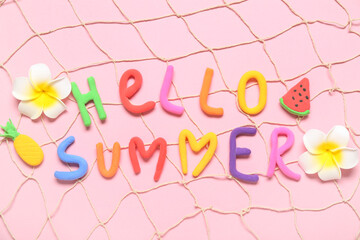 Composition with text HELLO SUMMER, tropical flowers and fish net on pink background
