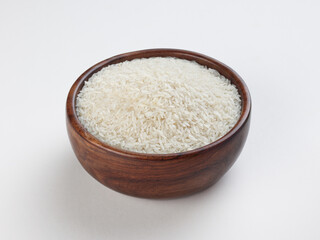 wooden bowl of rice isolated on white table
