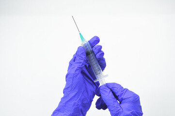 Vaccination concept. Hand in medical glove with syringe. Partial view of doctor holding syringe...