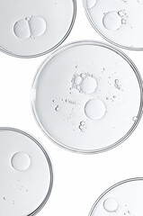 The texture of a cosmetic serum or body gel in a Petri dish.