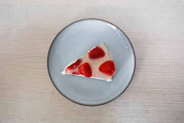 A slice of cake with strawberries on top.