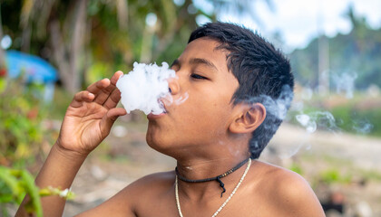 Naklejka premium boy lips blowing smoke clouds