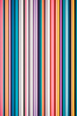 A vibrant array of vertical stripes in various colors including pink, purple, blue, and white, creating a lively and modern abstract pattern.