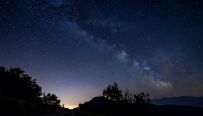 Fototapeta premium Night Sky Panorama Milky Way Galaxy Over Silhouetted Trees
