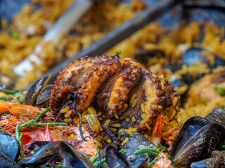 Rice Paella with seafood fish in provence market detail