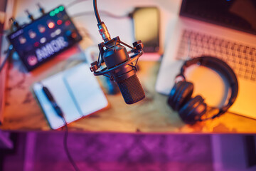 A microphone and podcasting setup. The image might be useful for generative AI content. The text on the box reads: "AMOR".