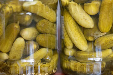 Close-Up of Glass Jar Containing Fresh Pickled Gherkins on a Wooden Surface