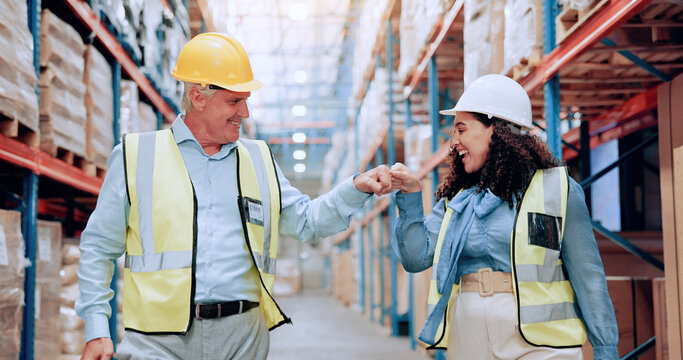 Man, woman and fist bump for logistics at warehouse, smile and success with motivation, team and support. People, mentor and happy with respect, celebration and goal for supply chain at storage plant