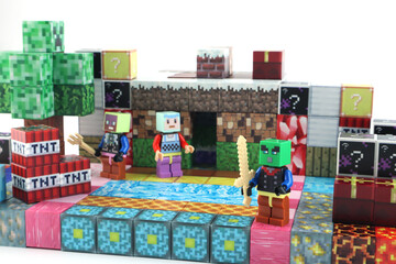 Fototapeta premium minecraft magnetic building toy blocks , from online virtual world game series are display on white table with many kinds of minecraft blocks , tnt magma stone wood grass water and cute characters