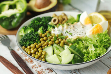 A bowl with a salad made of green vegetables