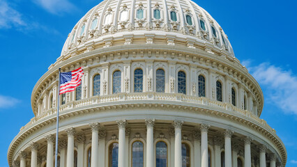 Fototapeta premium close-up of the Capitol Dome in Washington, D.C. and the American flag in the wind.