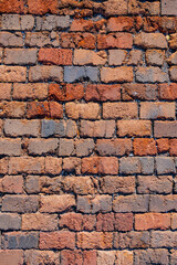 cracked fragment of an old red brick wall,