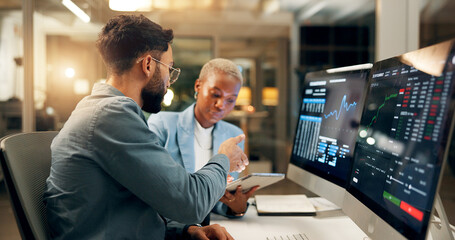 Computer screen, night and tablet with business people in office together for stock market trading. Conversation, feedback or review with investment team in workplace for portfolio management