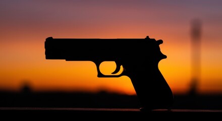 Gun silhouette sunset dramatic shadow violence prevention awareness