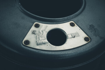 Detailed inspection of a vintage mechanical gauge showing wear and dim lighting in a workshop