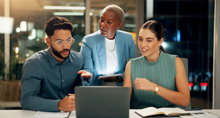 People, meeting and laptop in office at night for planning, story ideas and project deadline. Man, explain and brainstorming with team, research and article schedule for publication for working late © peopleimages.com