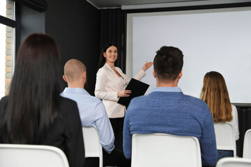Business people at seminar in conference room with video projection screen