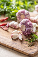 Close-up Garlic Cloves and Bulbs with rosemary salt and pepper