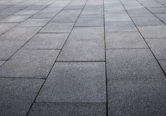 Natural gray granite stone pavement surface detail. Sone pavement texture, gray tiles. 