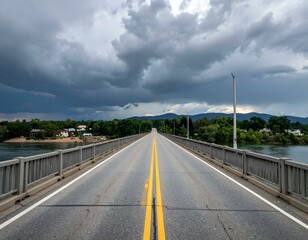 Fototapeta premium Scenic highway bridge over river under dramatic stormy sky. Perfect for travel, nature, and transportation themes.