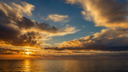 Naklejka premium Dramatic Golden Hour Sunset over Calm Ocean with Cloudscape