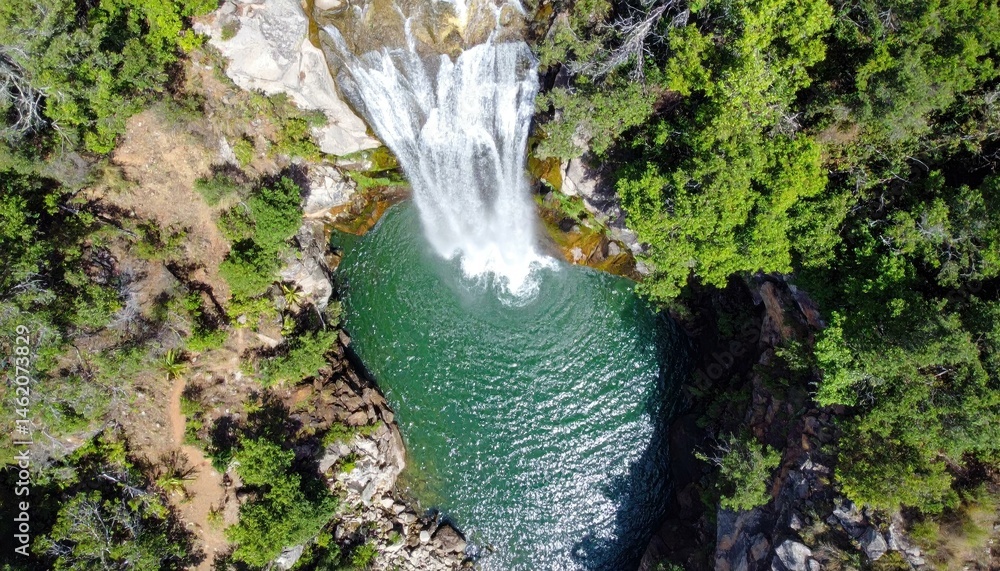 Aufkleber aerial view of a waterfall cascading into a pristine green pool surrounded by lush forest. perfect f