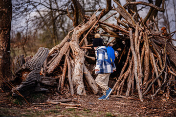 Child Playing with Stick Near Forest Fort