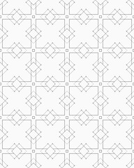 A seamless geometric design showcases a repeated pattern of crosses and diamonds, creating a striking visual effect on a white surface